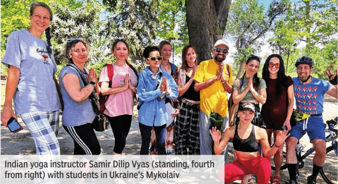 Indian yoga instructor Samir Dilip Vyas (standing, fourth from right) with students in Ukraine’s Mykolaiv