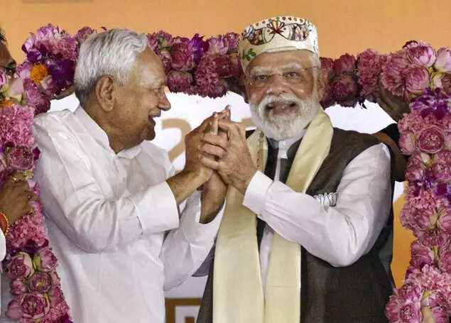 Prime Minister Narendra Modi and Bihar Chief Minister Nitish Kumar being garlanded during a public meeting ahead of the state Assembly elections, in Samastipur district. (PTI Photo)